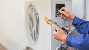 Air conditioning, HVAC service technician using gauges to check refrigerant and add refrigerant